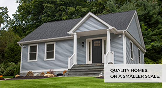 Compact gray home with a covered front entry. Quality homes on a smaller scale.