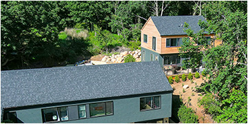 Backyard cottage surrounded by trees.