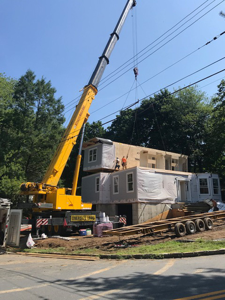 crane placing modular home